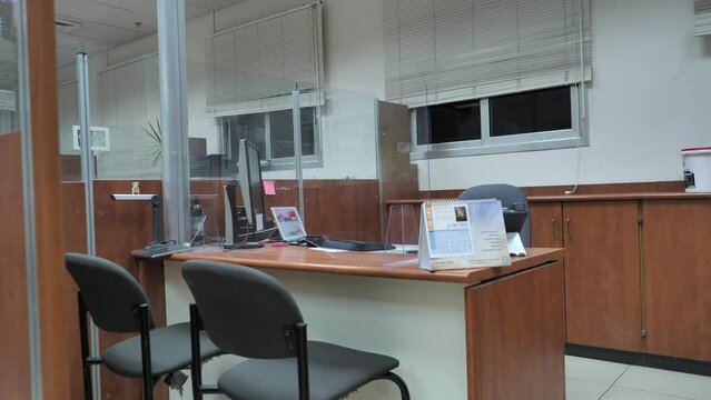 Turning off light in empty bank office at the end of shift 