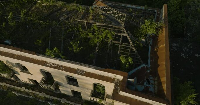 Ruins Of Abandoned Soviet Sanatorium Overgrown By Plants In Tskaltubo, Georgia. aerial arc shot