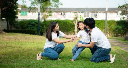 A little girl was slightly injured while playing with her parents comforting her at her side.