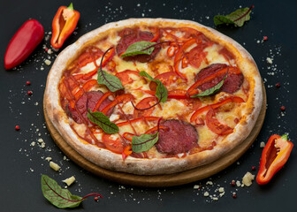 Spicy pizza with salami and sweet pepper. Italian traditional food. Popular street food.