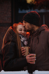 Outdoors Valentines Day Date Ideas for Couples. Winter love story. Cold season dating for couples. Young couple in love in neon lights in evening night winter city street