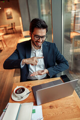 Businessman have a business meeting via video call and communicates using sign language in cafe