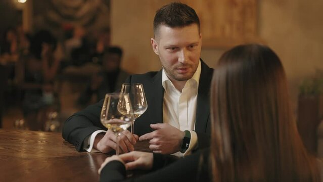 people rest in restaurant and bar in weekend evening, portrait of handsome man talks with lady