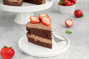 Naked chocolate cake with cream and fresh strawberries on top. Rustic style. Selective focus. Copy space.