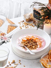 muesli with milk and pink strawberry yogurt 