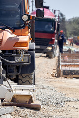 Heavy construction machines and truck outdoors for public place reconstruction.