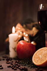 Christmas composition coffee beans, orange, wine, candle. New Year's table