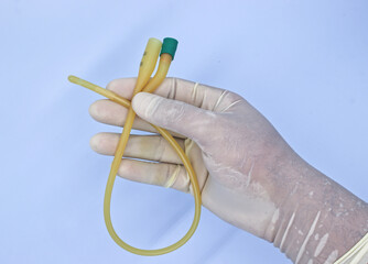 nurse holding urinary catheter prior to use.