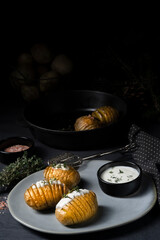hasselback potatoes with quark and herbs on the plate