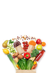 Healthy food background. Healthy food in paper bag vegetables and fruits on white. Shopping food...