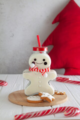 Milk and cookies for Santa. Milk is poured into a cute bottle in the shape of a gingerbread man. Christmas mood