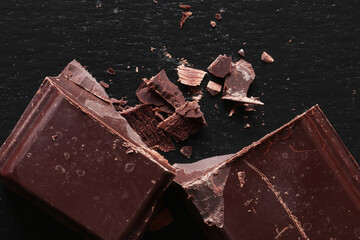 Photography of a cut block of dark chocolate on slate for food illustration