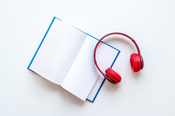 Audiobook or podcast concept with book and headphones nearby