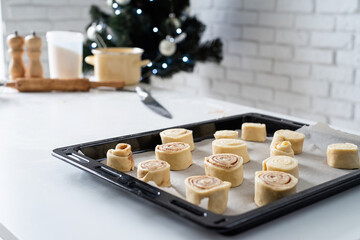 freshly made cinnamon rolls on the baking tray , festive cooking