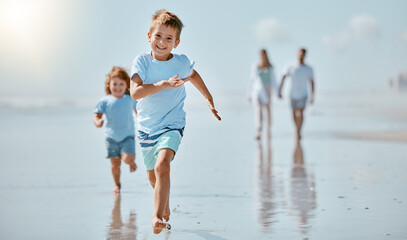 Kids, running and beach with a family on holiday or summer vacation together outdoor in nature. Children, travel and tourism with a brother and sister racing on the sand by the sea or ocean - Powered by Adobe