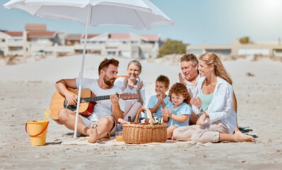 Beach picnic, guitar and big family on holiday for travel, relax and music entertainment in...