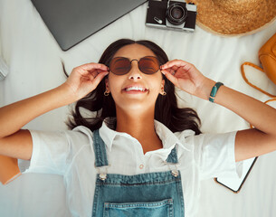 Travel packing, woman and happiness of a person with sunglasses on a hotel bed ready for adventure....