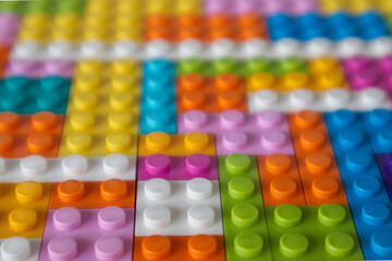 Multi-colored building blocks background top view copy space