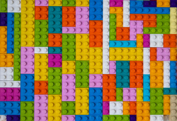 Multi-colored building blocks background top view copy space