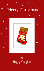 Christmas card with a red gift sock and Santa in a red checkered hat on a red backdrop. The sock is in the white frame. There are also white stars, snowflakes and Christmas inscriptions. JPG file.