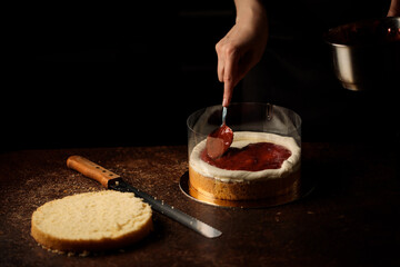 the process of assembling a biscuit cake in acetate film