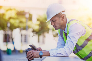 Construction engineer, man and coffee with phone for typing, reading notification or architect...