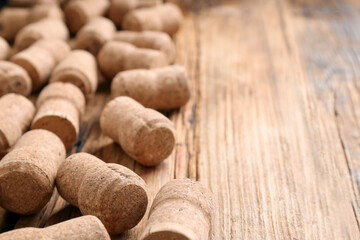 Sparkling wine bottle corks on wooden table, closeup. Space for text