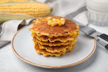 Tasty corn pancakes on light grey table, closeup