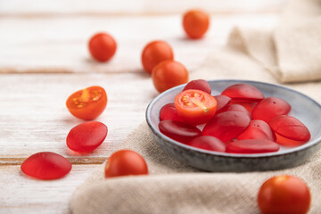 Jelly tomato candies on white wooden background. close up, side view, selective focus.