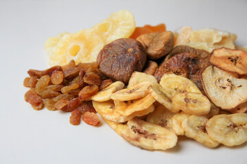 Pile of different dried fruits on white background, closeup