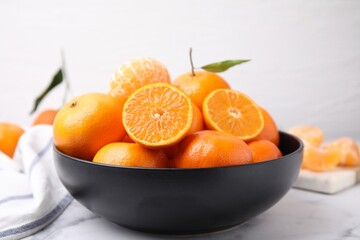 Fresh juicy tangerines on white marble table