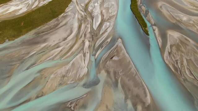 Aerial - river delta with turquoise glacier water flowing into Lake Tekapo, New Zealand