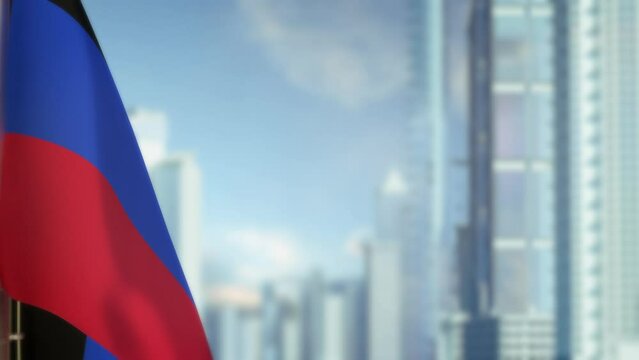 hanging Donetsk Peoples Republic flag on city background with blue sky