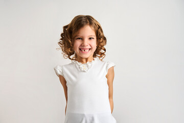 Close-up portrait of a child girl with curly hair