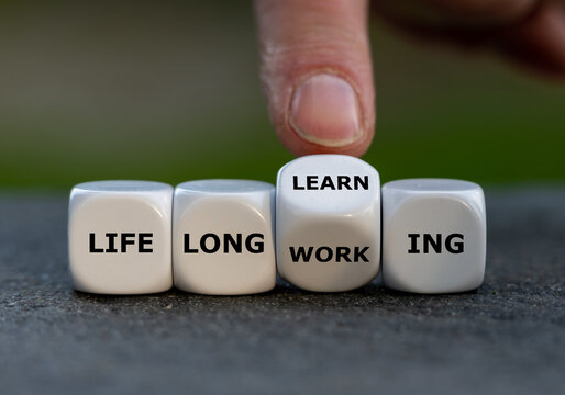 Hand turns dice and changes the expression 'life long working' to ' life long learning'.