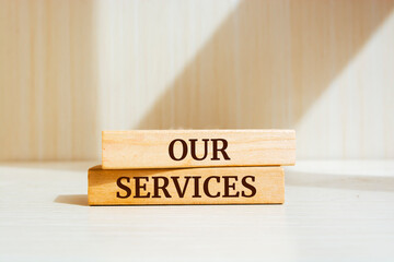 Wooden blocks with words 'our services'.