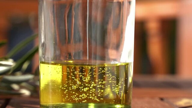 Oil is poured into a bottle. Vegetable oil based on natural ingredients as the basis of cosmetics, beauty and medicine products.
