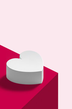 Valentine&rsquo;s Day minimal concept with white heart shaped box on magenta and pastel pink perspective background. Romantic flat lay composition.