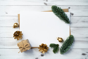 Mockup for a letter or a Christmas invitation with gold fir cone	
