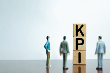 KPI,Key Performance Indicator for target achievement,planning concept.,Three Businessman looking wooden cube with KPI word over white background with copyspace.business idea.