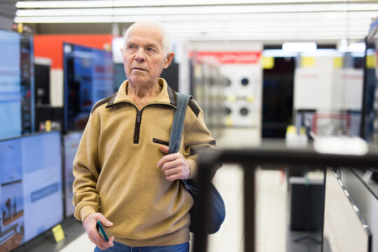 Senor Man Pensioner Buying Modern Digital Televisor With Smart Tv In Showroom Of Digital Electronic Goods Store