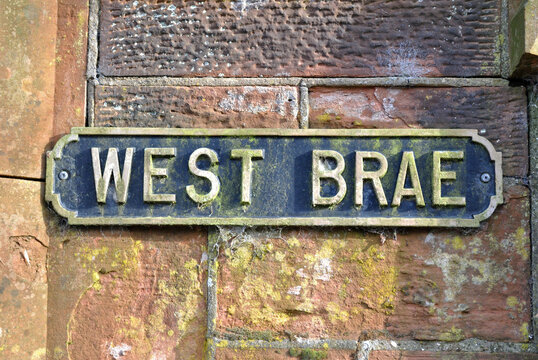 Close Up of Cast Iron Road Sign 'West Brae'  on Old Stone Wall 