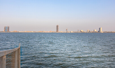 blue ocean with city skyline view