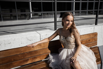 portrait of a beautiful young woman with makeup in a delicate dress