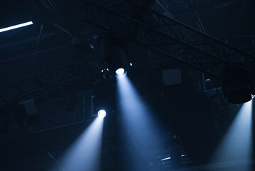 A beam of light from a moving light head on a black background. Stage light design