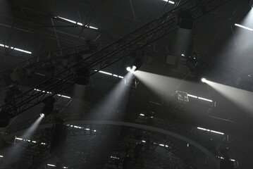Moving head light on black background with light trusses