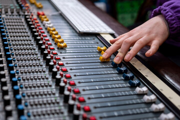 Sound control panel professional. Sound designer working on the sound control. Man working on professional digital audio channel mixer in studio