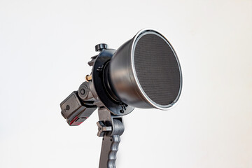A reflector for photographing with a cellular grid complete with a flash on a white background