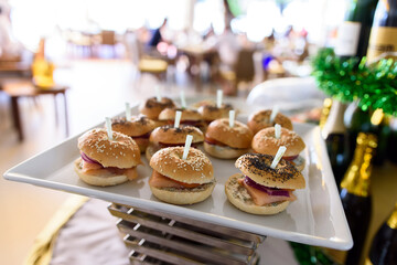 Close-up of appetizer snacks mini burgers on a white plate