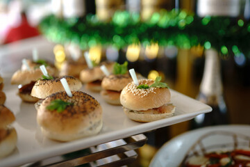 Close-up of appetizer snacks mini burgers on a white plate